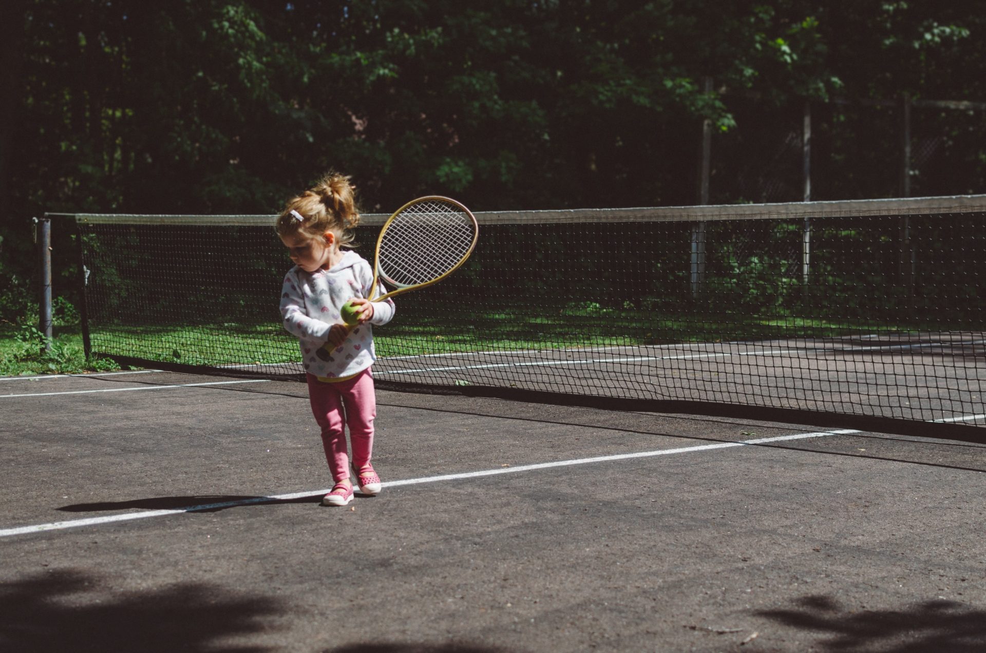 photo of child on tennis court by Kelly Sikkema on