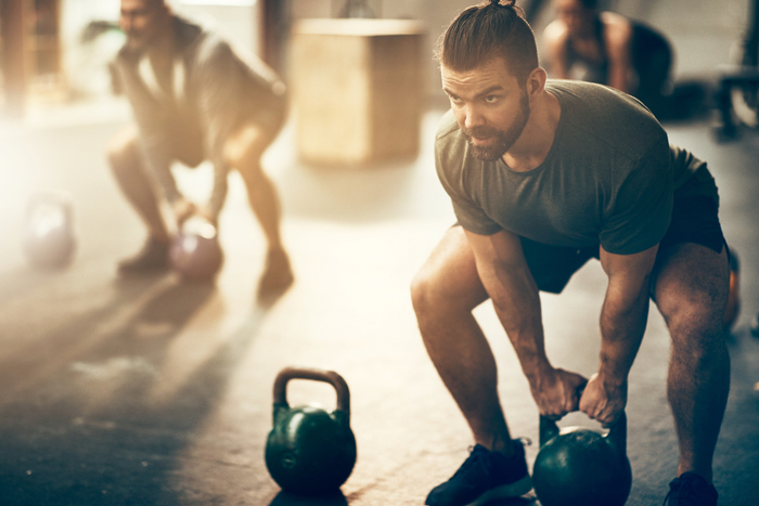 Fit,Young,Man,In,Sportswear,Focused,On,Lifting,A,Dumbbell